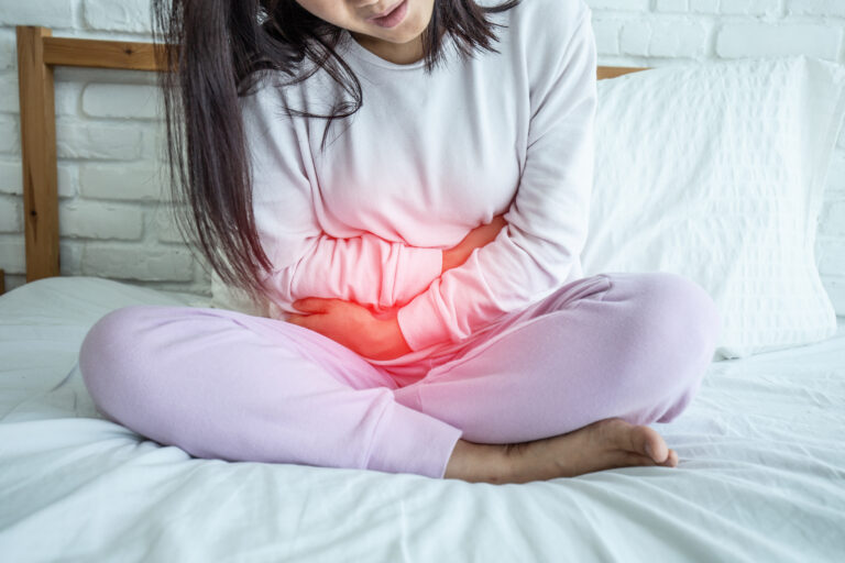 woman have pelvic pain sitting on bed in bedroom after wake up feeling so sick and painful